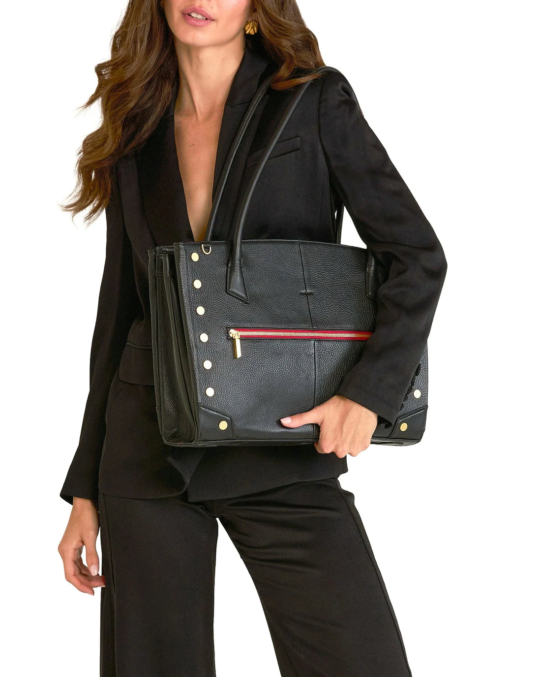 A structured black leather tote carried on the shoulder