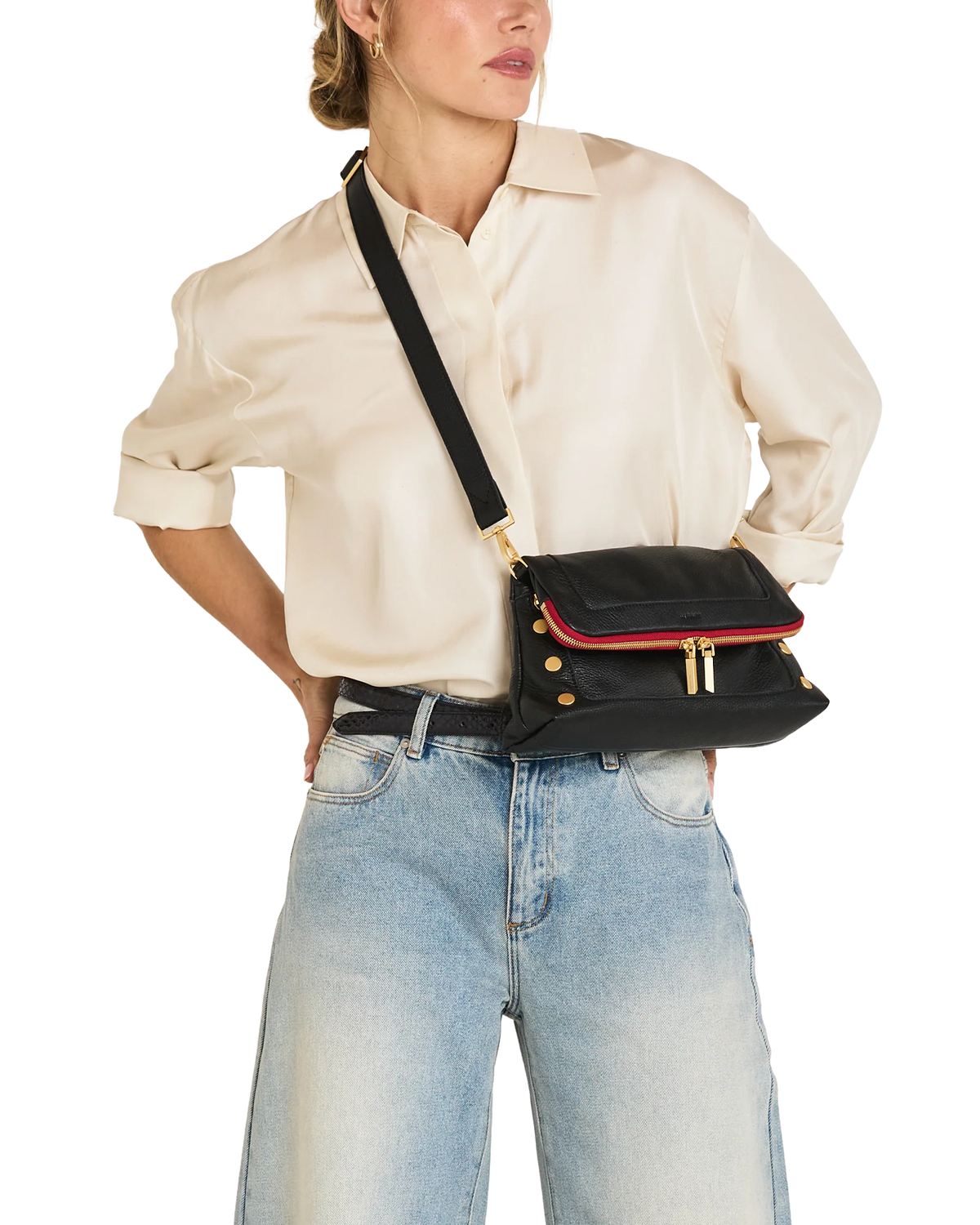 The bag worn crossbody over a cream shirt