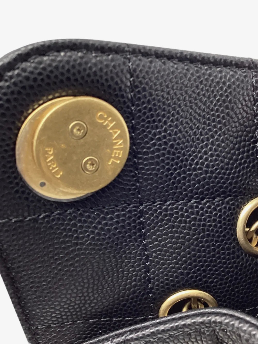 Gold-tone CHANEL Paris stud on the quilted caviar leather
