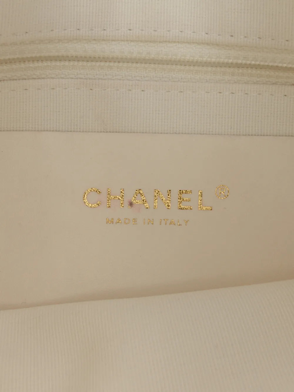 Chanel white quilted hobo bag, three-quarter angle showing the chain trim