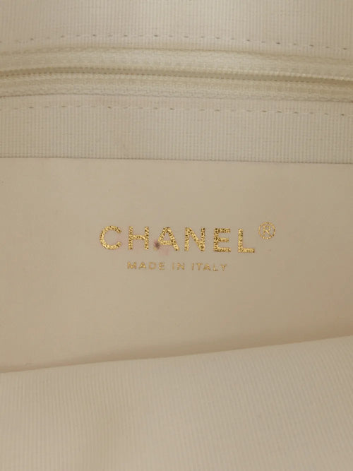 Chanel white quilted hobo bag, three-quarter angle showing the chain trim
