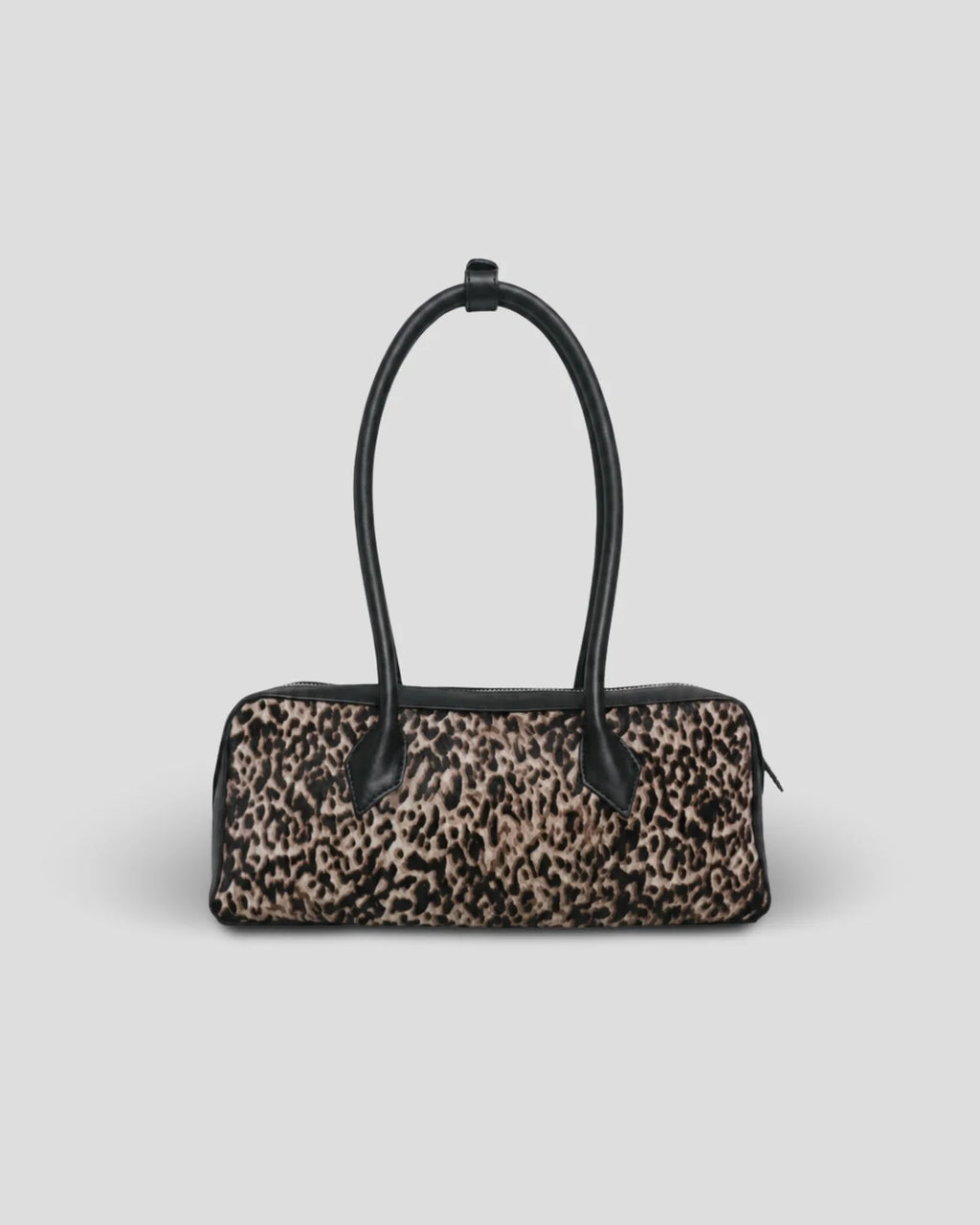 The Cila Cow Print Bag, front view with the handles standing up