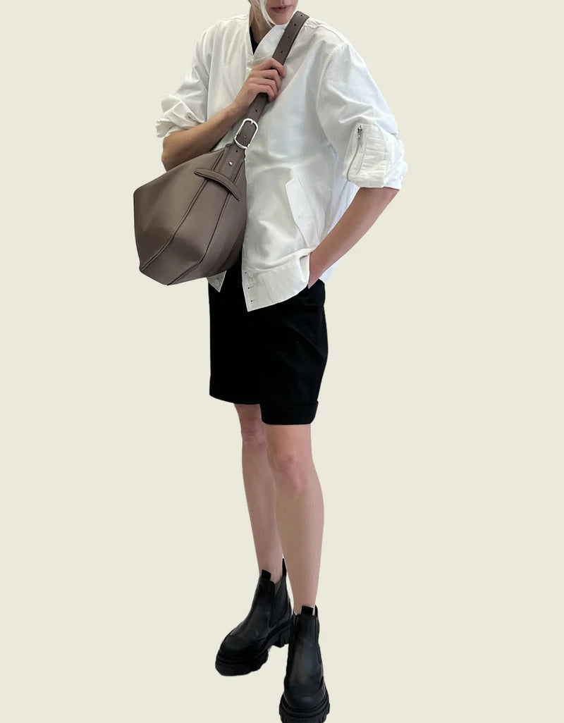 The taupe leather bag carried on the shoulder