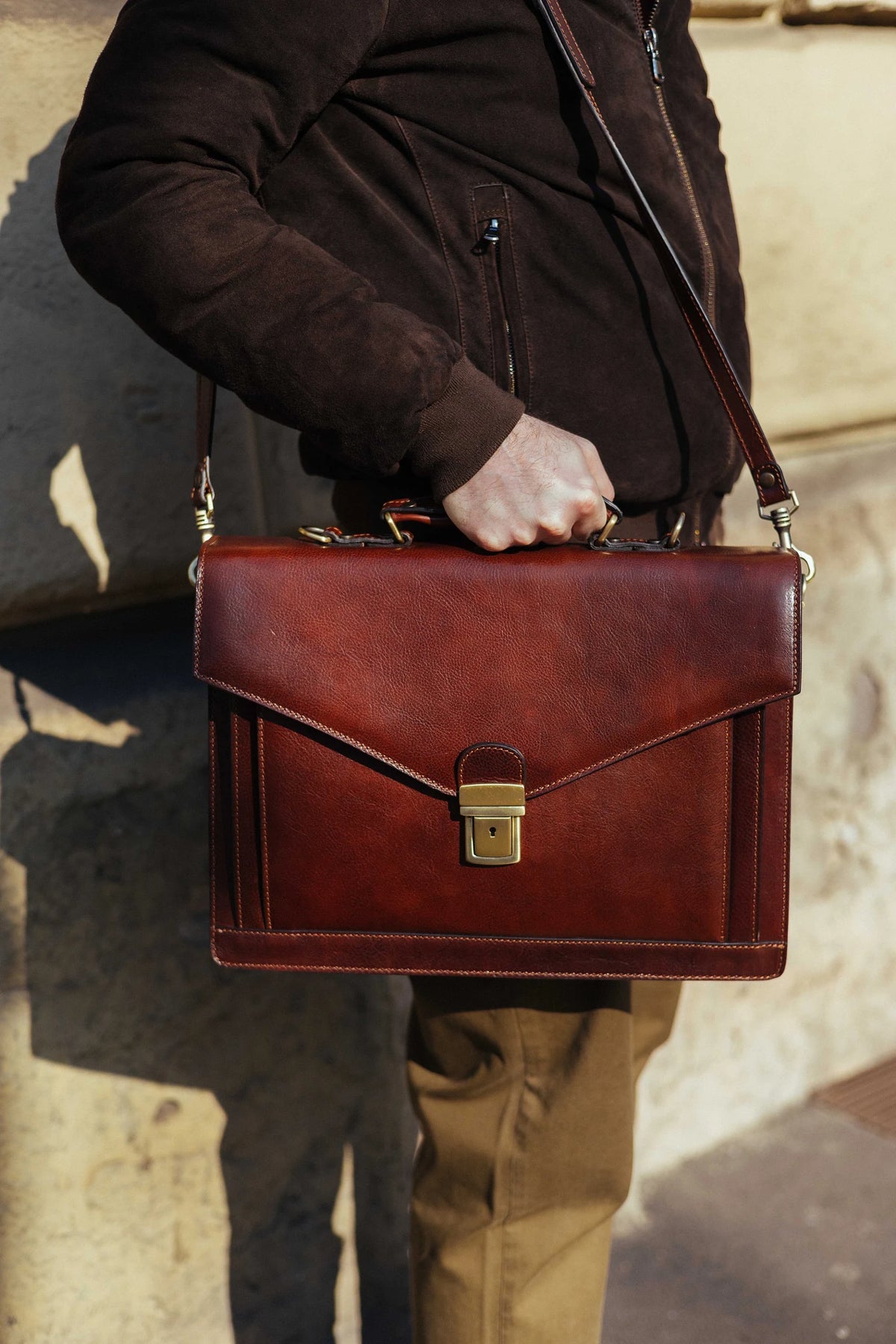 Cognac Italian leather briefcase carried by its top handle