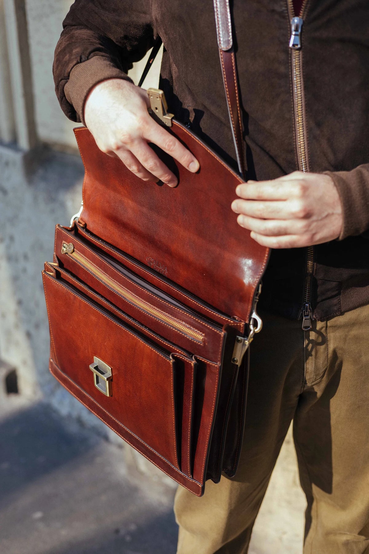 Briefcase opened, showing two main compartments and the zipped pocket